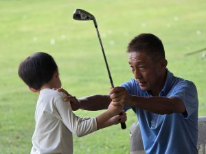 Coach Lim Kian Kee with private junior golf lesson taker